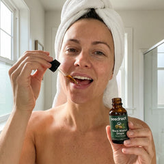 Woman taking Seedroot Black Walnut Drops as part of her morning routine